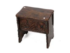 A 19th century carved oak jointed stool with storage.