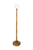 A mid-century turned oak standard lamp. Raised on a circular base.