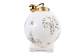 A white glass globe pendant ceiling light. Having printed floral decoration, brass fittings.