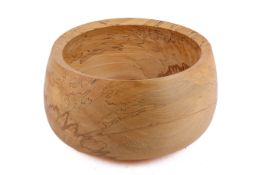 A large contemporary turned wooden fruit bowl.