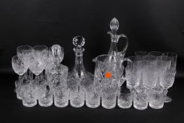 An assortment of glassware. Including cut glass beakers, wine glasses, a decanter, etc.