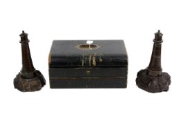 A Victorian writing slope and two Cornish Serpentine turned stone lighthouses.