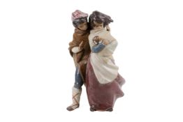 A Lladro pottery figure group.