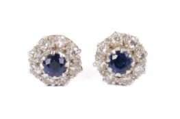 A pair of diamond and sapphire cluster earrings.