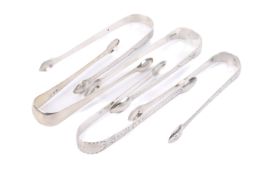 Five George III silver sugar tongs.