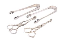 Two Georgian and later sugar tongs and two pairs of sugar nips.