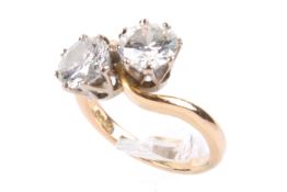 A red gold two stone diamond ring. Each round brilliant cut diamond of 1.00 carat estimated weight.