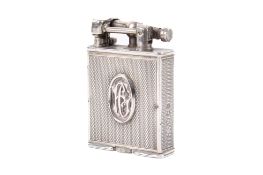 A Parker Beacon silver pocket lighter. With engine-turned panels and central oval monogram for FG.