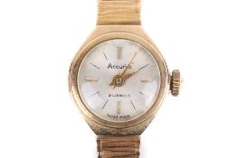 A ladies hallmarked 9ct gold Accurist dress watch. Circular dial, integral bark link bracelet.