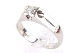 An 18ct white gold diamond solitaire ring. Set with one old brilliant cut diamond of circa 0.
