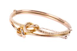 A 9ct yellow and rose gold double knot bangle.
