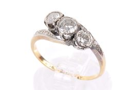 A gold and three stone diamond crossover ring.