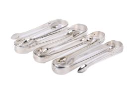 Seven silver sugar tongs.