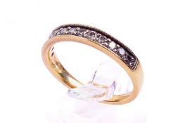 An 18ct gold and diamond half eternity ring. Marked 0.33 ct of stones, maker's stamp A.T. Ld.