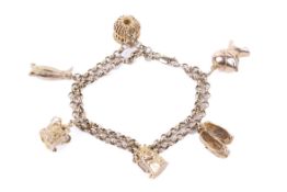 A 9ct gold double cable chain bracelet hung with six charms.