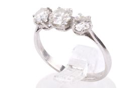 A three stone diamond ring. Set with three round brilliant cut diamonds of 1 - 1.