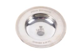 A small silver salver commemorating the opening of the Stock Exchange.