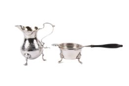 A silver milk jug, condiment dish and tea strainer.