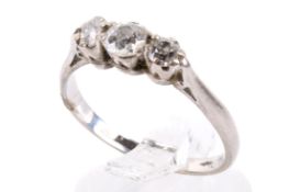 A white metal three stone diamond ring.