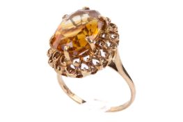 A yellow metal dress ring set with one oval faceted citrine of 5.75 carats approximately.