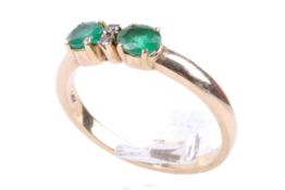 A 14ct gold, emerald and diamond ring.