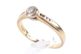 A yellow gold diamond solitaire ring. Set with one round brilliant cut diamond of estimated 0.