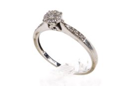 A white gold cluster ring. Set with round brilliant and single cut diamond diamonds of circa 0.21ct.