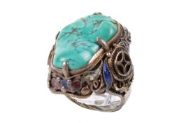 A Chinese silver and turquoise ring. The large natural shaped turquoise of circa 2cm x 1.