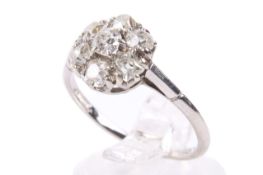 An 18ct white gold diamond cluster ring. With seven diamonds in flower form of circa 3.