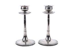 A pair of sterling silver hallmarked filled candlesticks. Walker & Hall, Sheffield, 1908. H20cm.