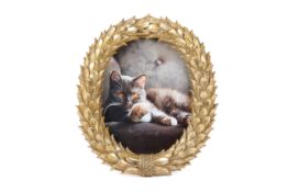 A contemporary gilt oval photo frame.