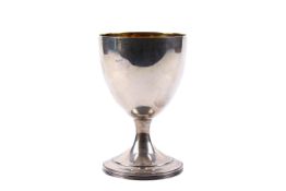 An Irish silver and gilt goblet. Undecorated, raised on a reeded base, the inside gilt.