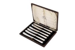 A set of six silver butter knives.