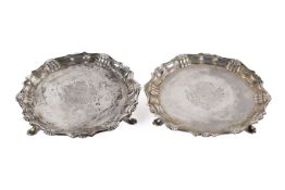 A pair of George II silver waiters.