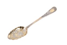 A George III table gilt silver table spoon. With a waved edge, decorated with flowers and leaves.
