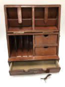 A modern leather covered desk tidy opening as a slope top cabinet with various pigeonholes and