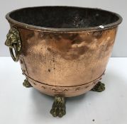 A Victorian copper copper of typical form now with lion mask ring handles and brass paw feet as a