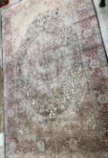A Persian wool and silk rug, the central