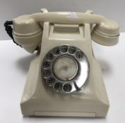 An ivory bakelite/plastic type cased tel