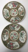 A pair of Chinese famille rose chargers decorated with panels of flowers bearing blue under glazed