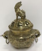 A Chinese bronze censer with pierced cover, the cover with Dog of Fo finial and script decoration,