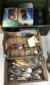 A box containing assorted plated cutlery and mustards,