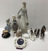 A collection of five various Nao porcelain figures, a Beswick horse figure and three foals,
