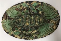 A 19th Century Pallisy style Majolica relief work dish decorated with central snake on shells