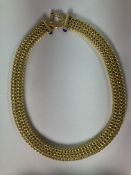 An 18-carat gold lapis lazuli set necklet of chain link form,