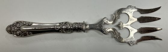 A sterling silver handled bread fork with four-pronged plated end, 24.