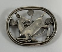 A Georg Jensen silver brooch depicting a deer kneeling,