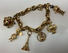 A 9-carat gold hollow link charm bracelet and six various charms,