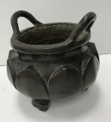 A Chinese patinated bronze censor with two plain loop handles,