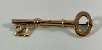 A 9-carat gold 21st key brooch, 1.